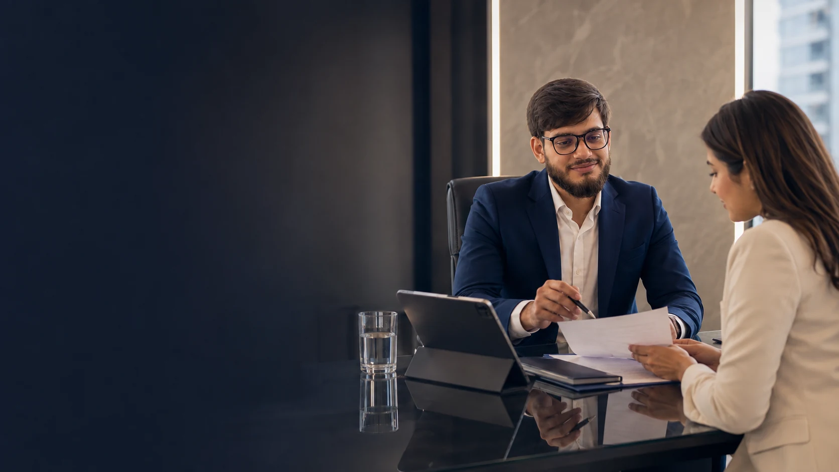 The CEO of Triple H Insurance Broker Company reviewing coverage options with a client.